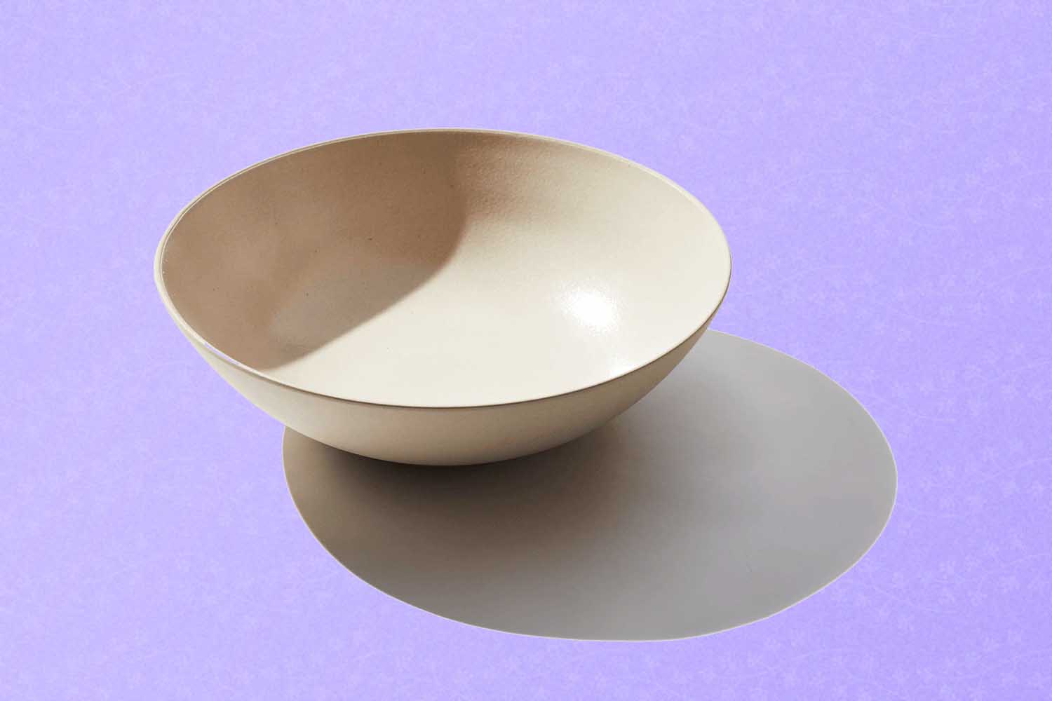 A ceramic serving bowl, a perfect Mother's Day gift for 2022, on a purple background.
