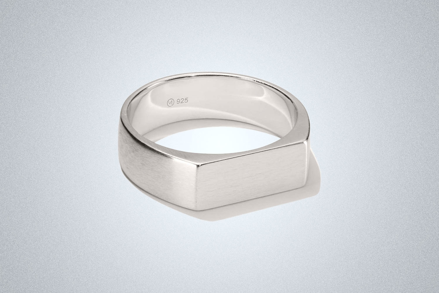 a silver singlet ring from Mejuri on a grey background