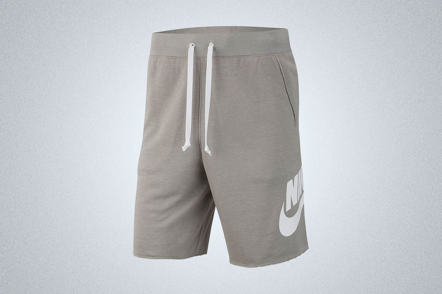 A pair of grey sweatshorts with Nike branding on a grey background