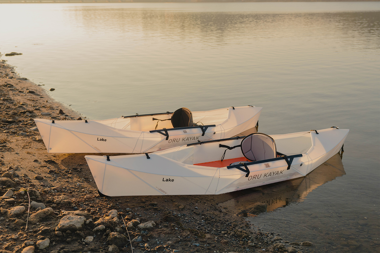 a pair of kayak on a lake bank