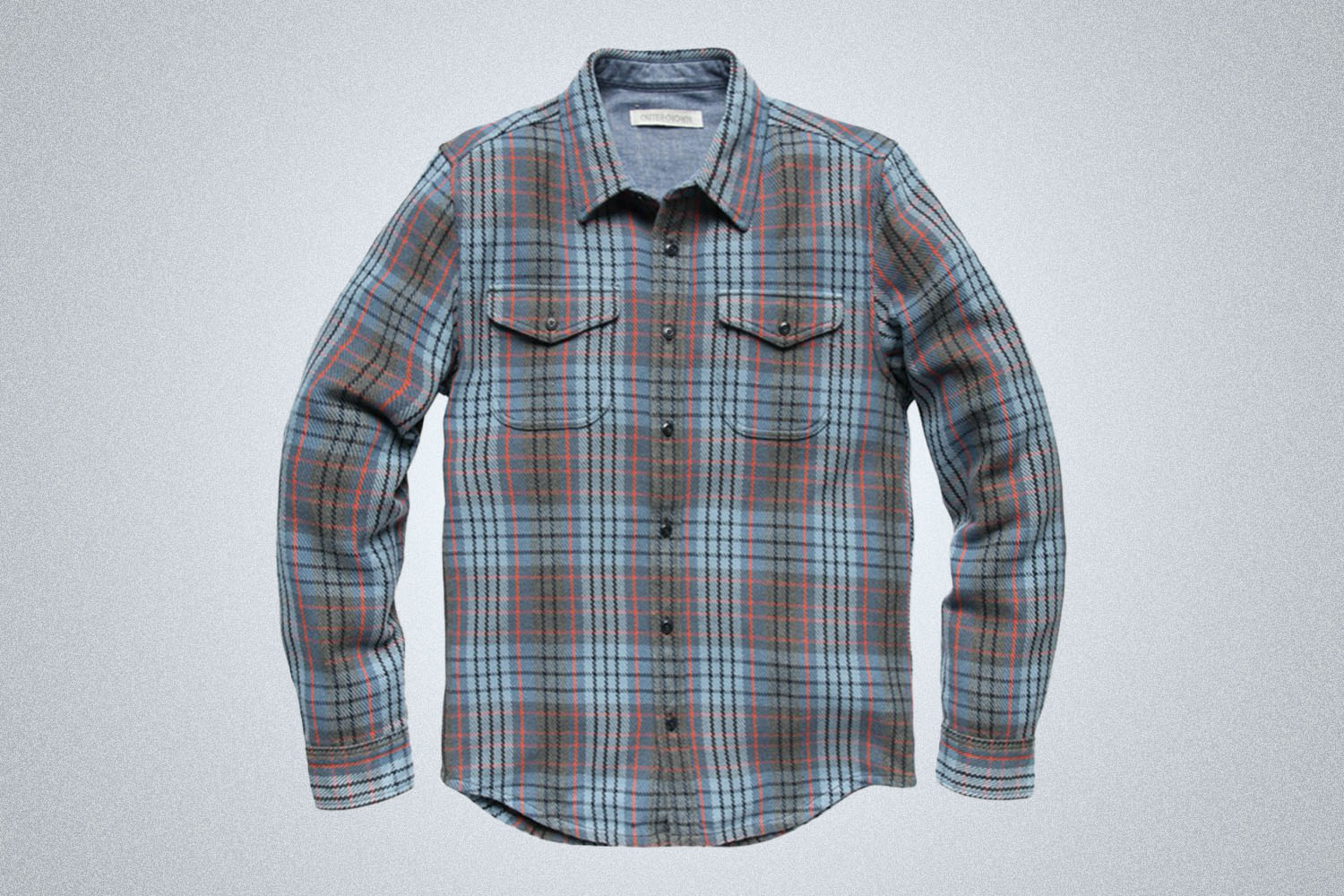 A blue striped shirt jacket from Outerknown on a grey background