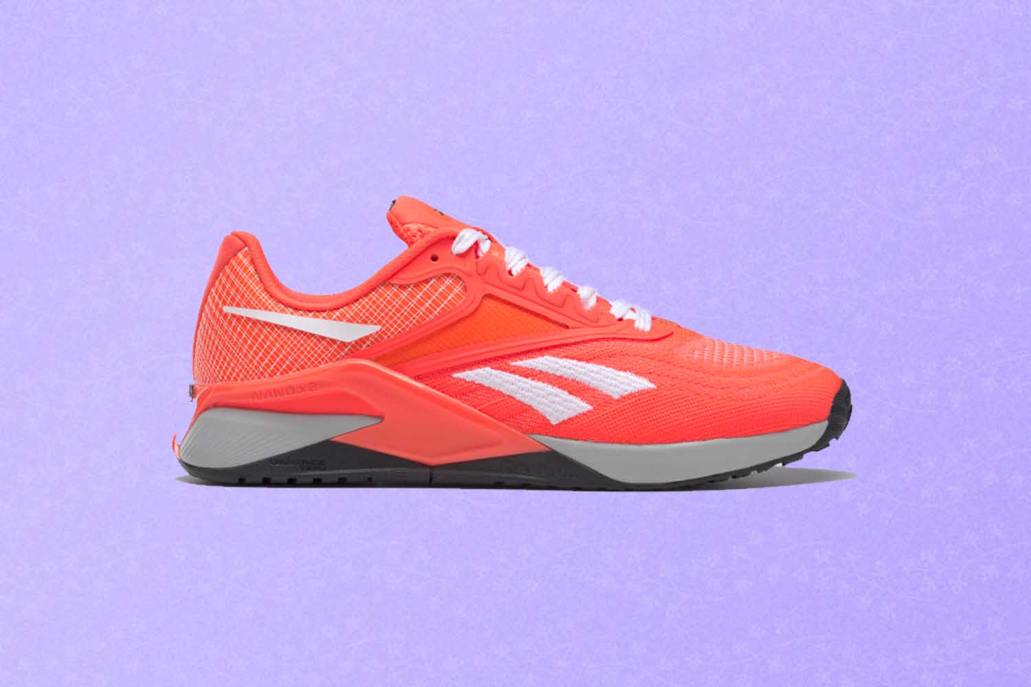 A pink training shoe, a perfect Mother's Day gift for 2022, on a purple background.