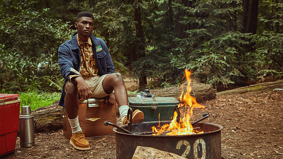 a model in L.L. Bean x Todd Snyder sitting in the forest