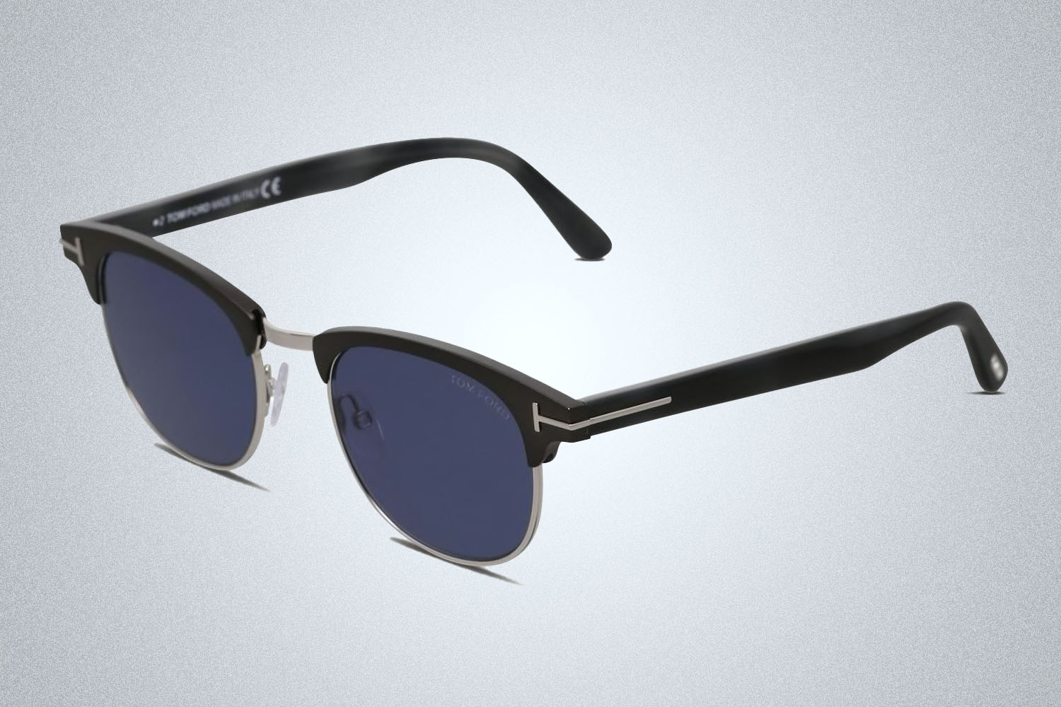 a pair of designer sunglasses from Tom Ford on a grey background