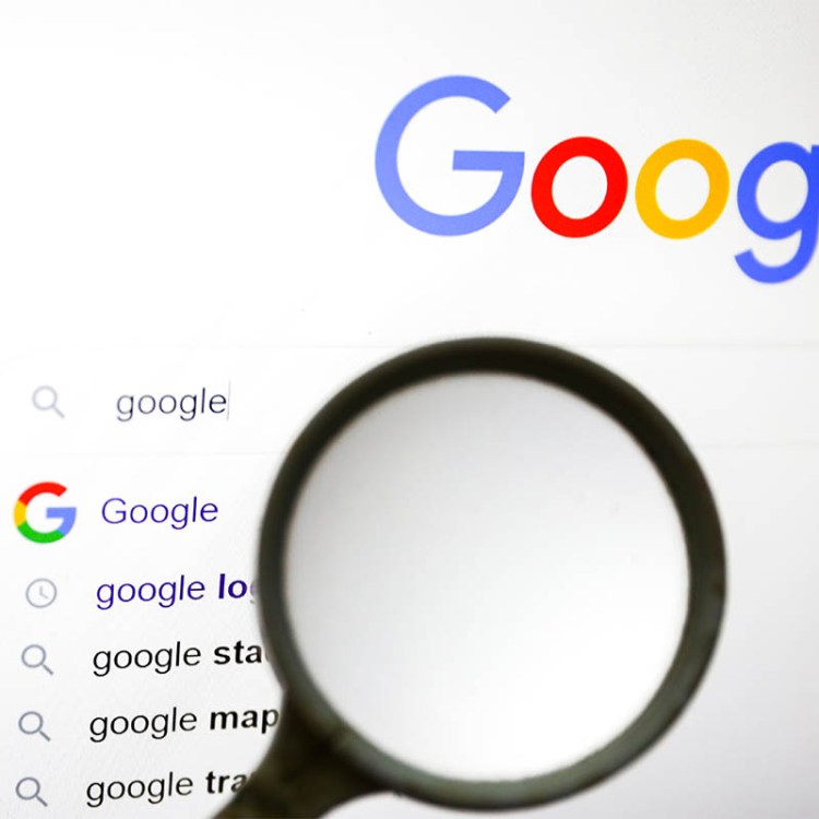 A magnifying glass is photographed with Google logo displayed on a laptop screen for illustration photo. Gliwice, Poland on January 23, 2022