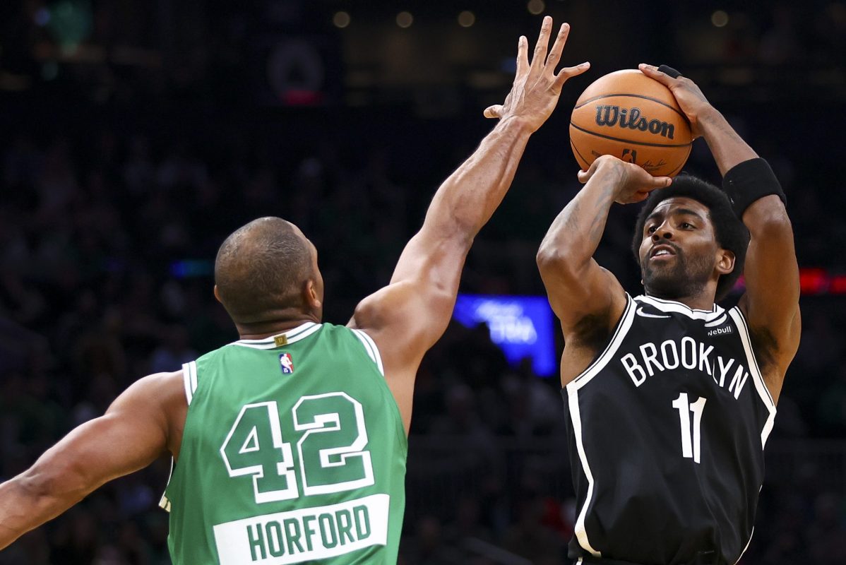 Kyrie Irving of the Nets shoots the ball over Al Horford of the Celtics