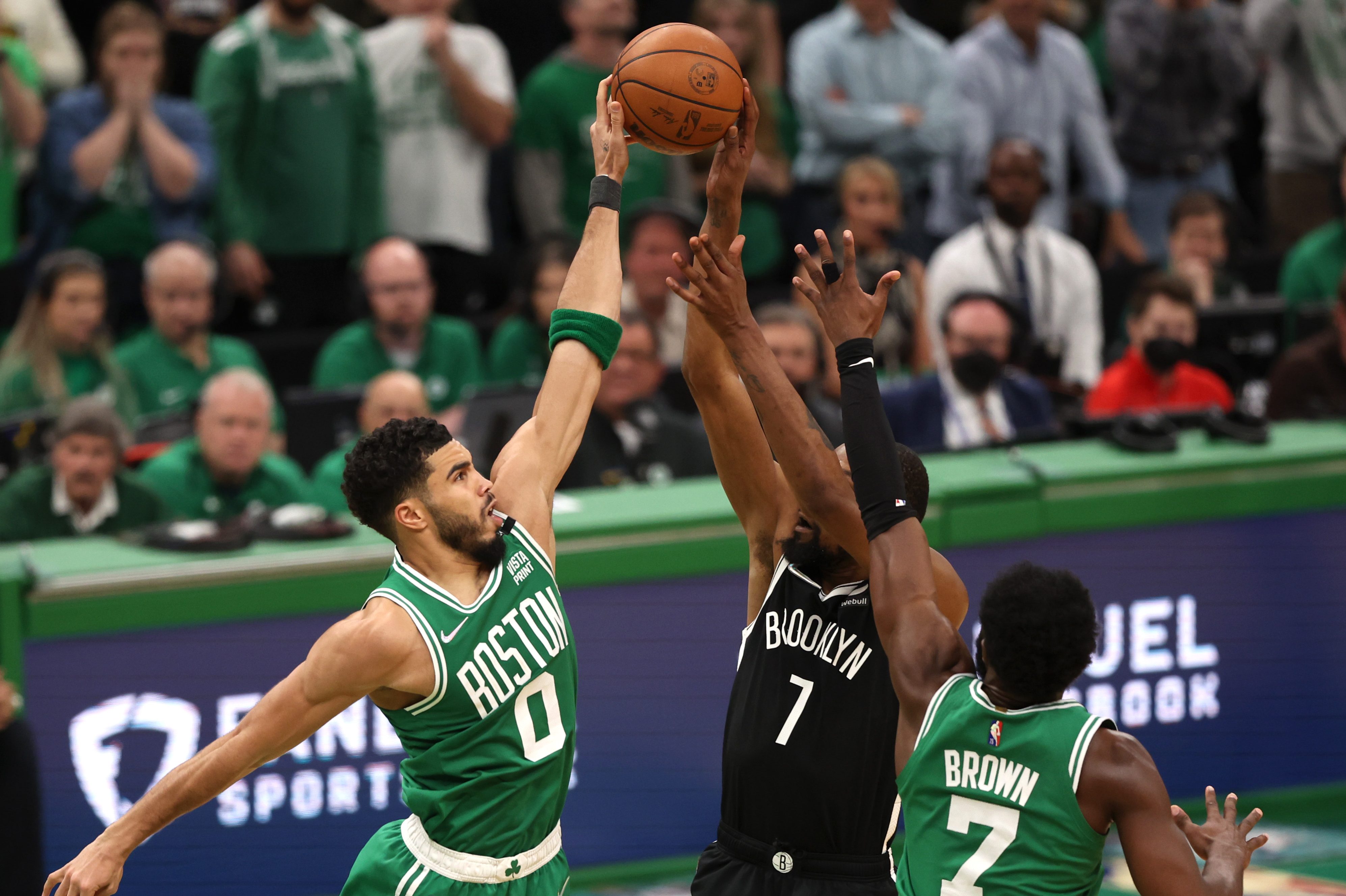 Jayson Tatum and Jaylen Brown defend a shot from Kevin Durant of the Brooklyn Nets