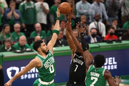 Jayson Tatum and Jaylen Brown defend a shot from Kevin Durant of the Brooklyn Nets