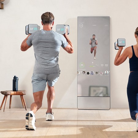 A woman and man working out with the Mirror, a home fitness device embedded in a reflective mirror. We take a look at why the home gym is the perfect Mother's Day gift for 2022.