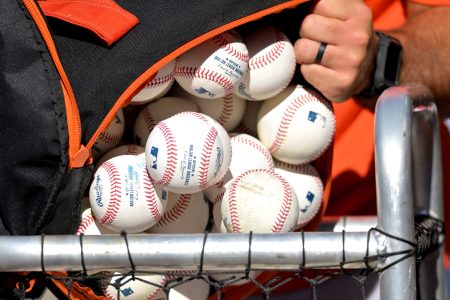 Batting practice baseballs loaded into a basket before a game