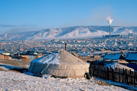 A traditional yurt in Ulaanbaatar, with factory smoke in the background.