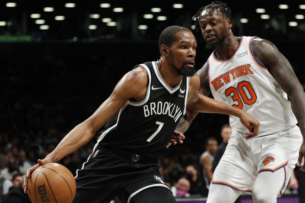 Kevin Durant of the Brooklyn Nets dribbles against Julius Randle of the New York Knicks