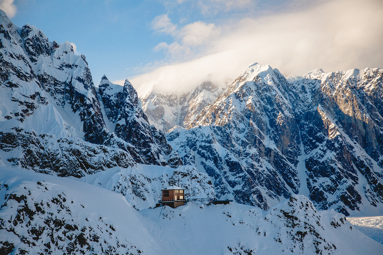 Sheldon Chalet, a remote, luxury destination in Alaska, pictured amongst the snow-capped mountains