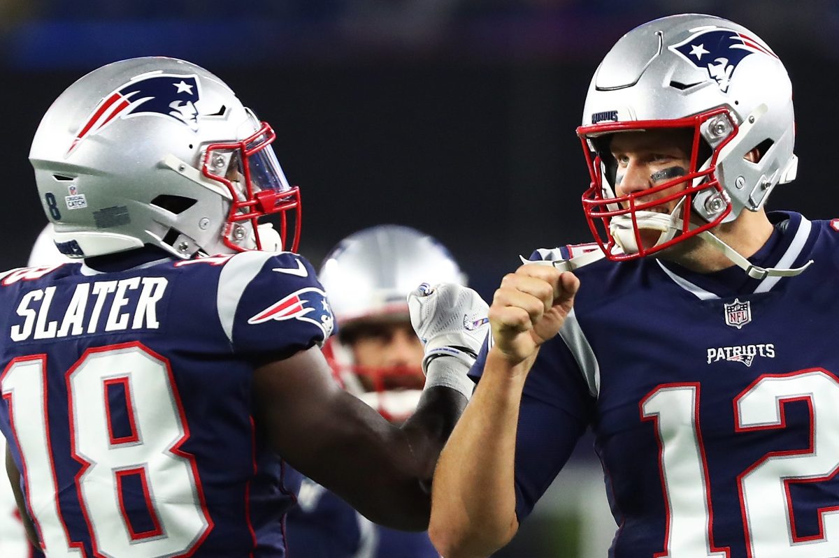 Tom Brady fist bumps Matthew Slater before a game against the Kansas City Chiefs in 2018