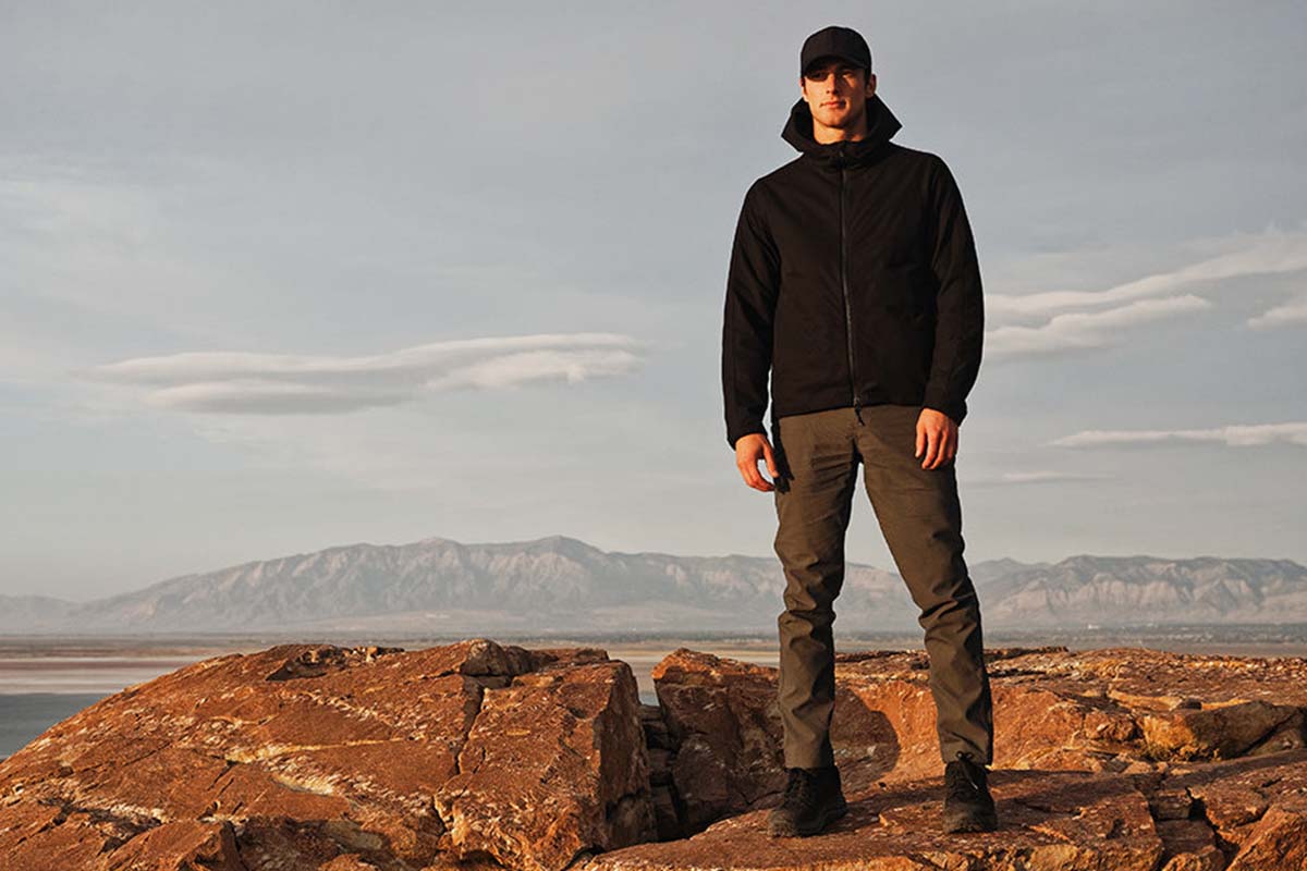A man in Western Rise gear on top of a mountain. Western Rise is one of 13 eco-friendly brands hosting a one-day sale in honor of Earth Month.