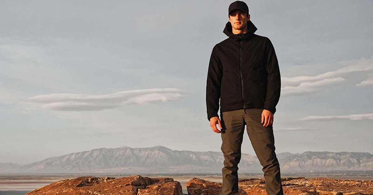 A man in Western Rise gear on top of a mountain. Western Rise is one of 13 eco-friendly brands hosting a one-day sale in honor of Earth Month.