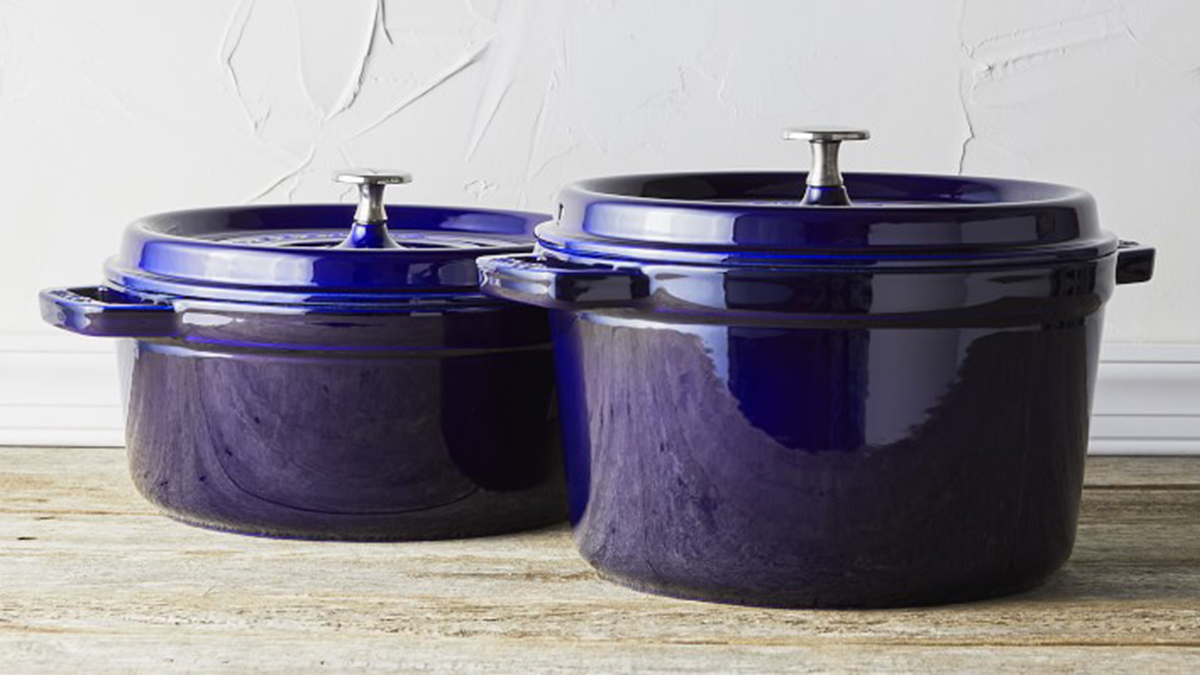 Two dark blue Dutch ovens from Staub on a countertop. Williams Sonoma is throwing a big Spring Cookware Event in April 2022 which sees discounts up to 60% off Staub and other top brands.