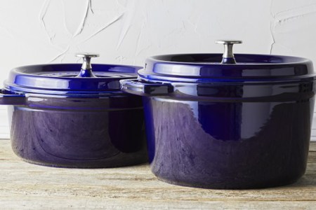 Two dark blue Dutch ovens from Staub on a countertop. Williams Sonoma is throwing a big Spring Cookware Event in April 2022 which sees discounts up to 60% off Staub and other top brands.
