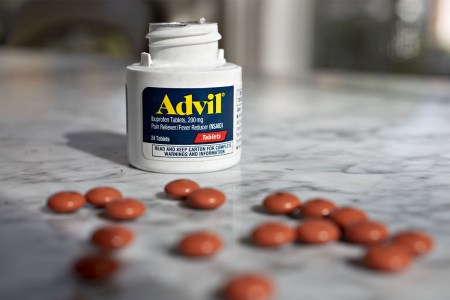 A bottle of Advil on a table.