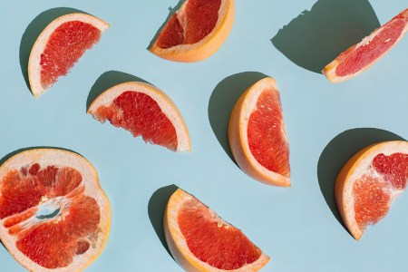 Slices of grapefruit against a blue background.