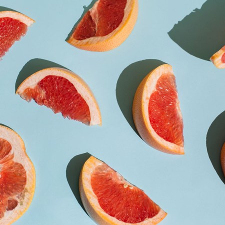 Slices of grapefruit against a blue background.