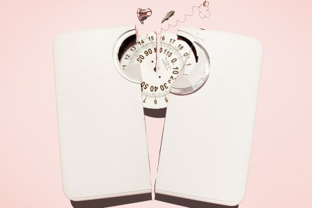 A broken scale on a pink background.