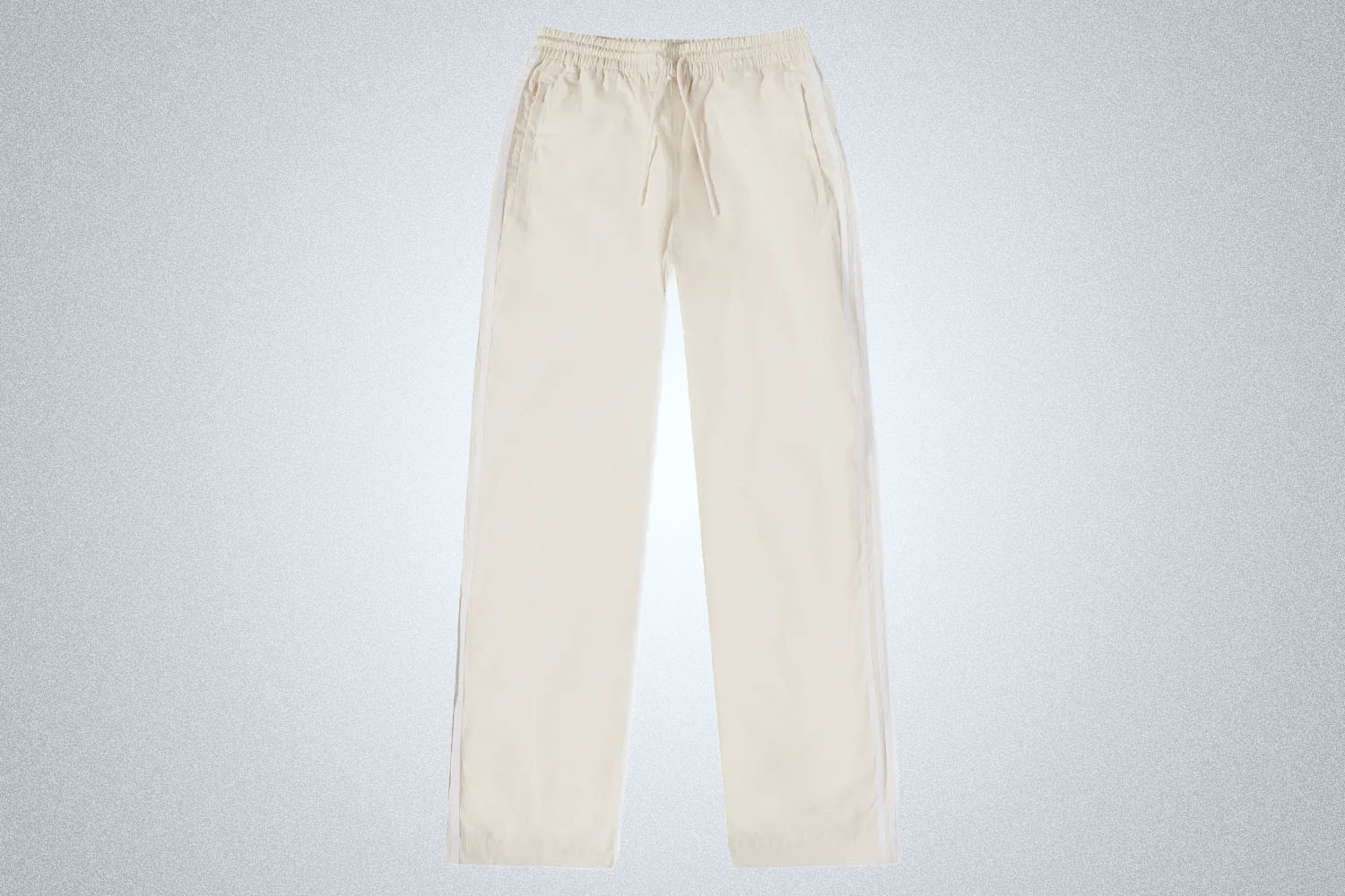 a pair of white pants from Adidas on a grey background