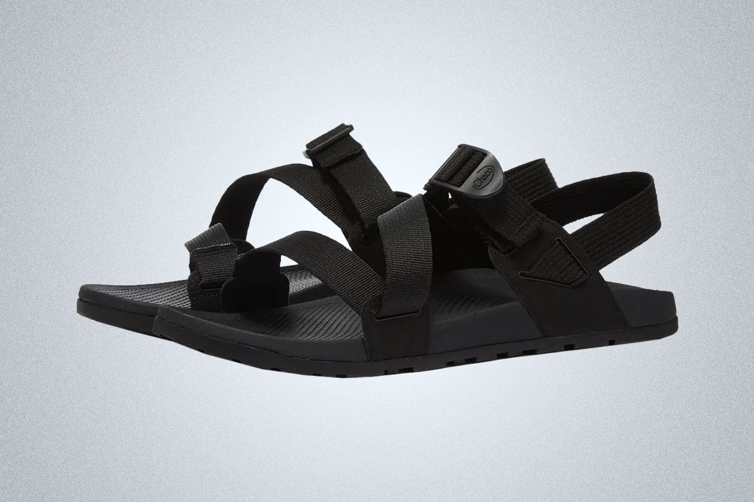 a pair of black slide sandals from Chacos on a grey background