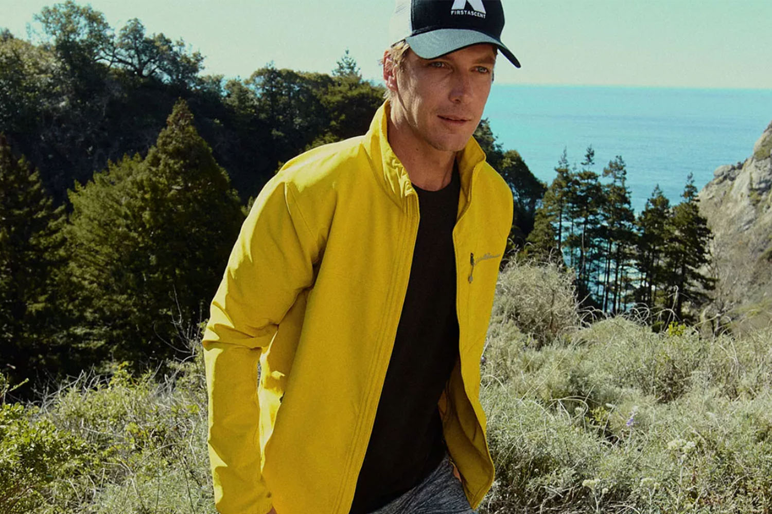 a model in a Eddie Bauer yellow rain jacket outdoors