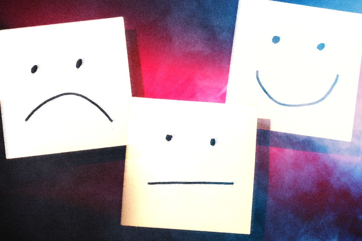 Faces drawn on sticky notes show different emotions