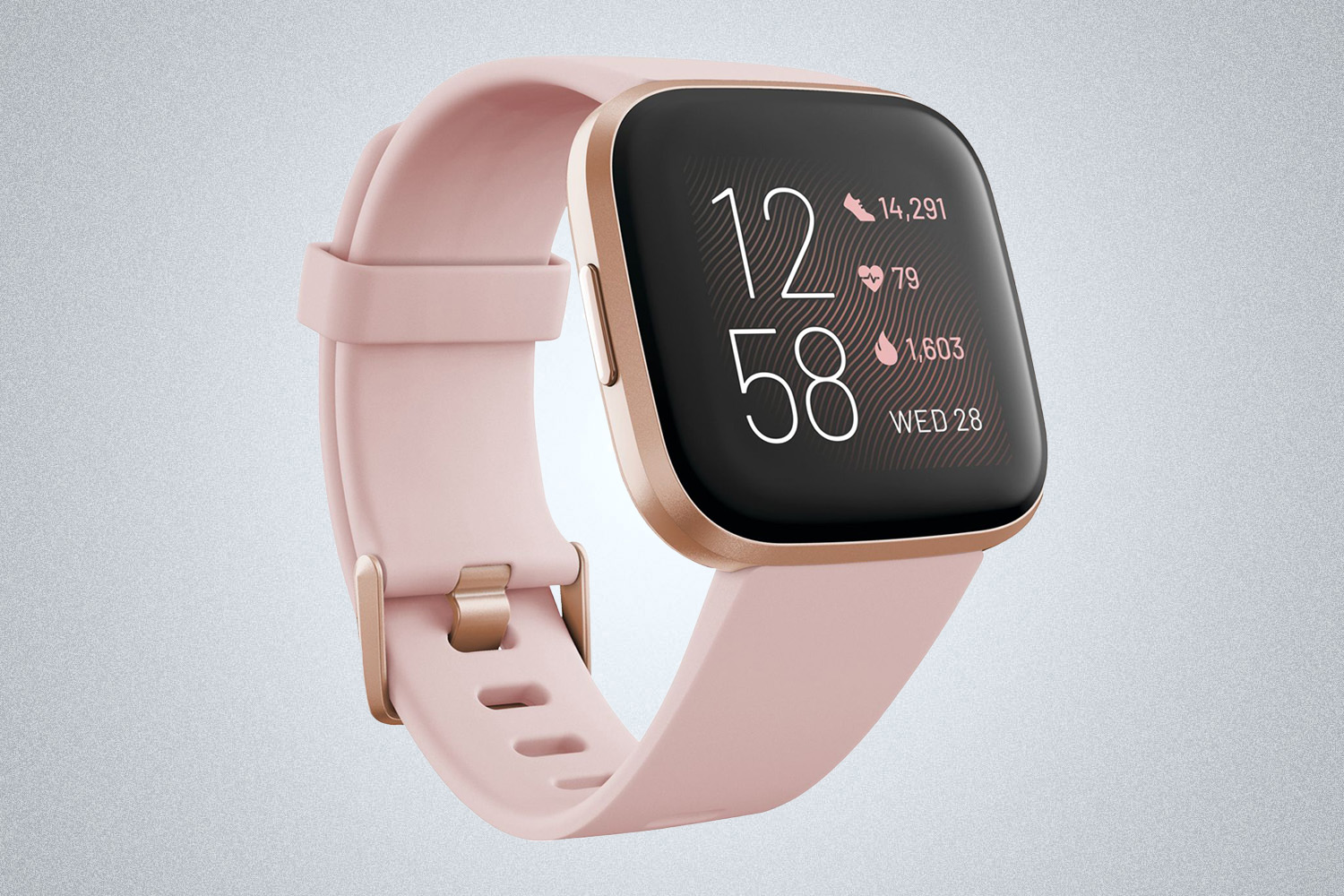 a pink smart watch from Fitbit on a grey background