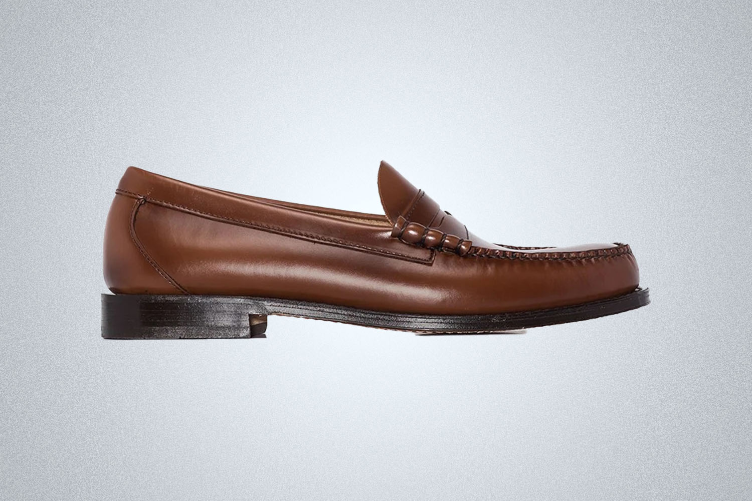 A pair of brown loafers from G.H. Bass on a grey background