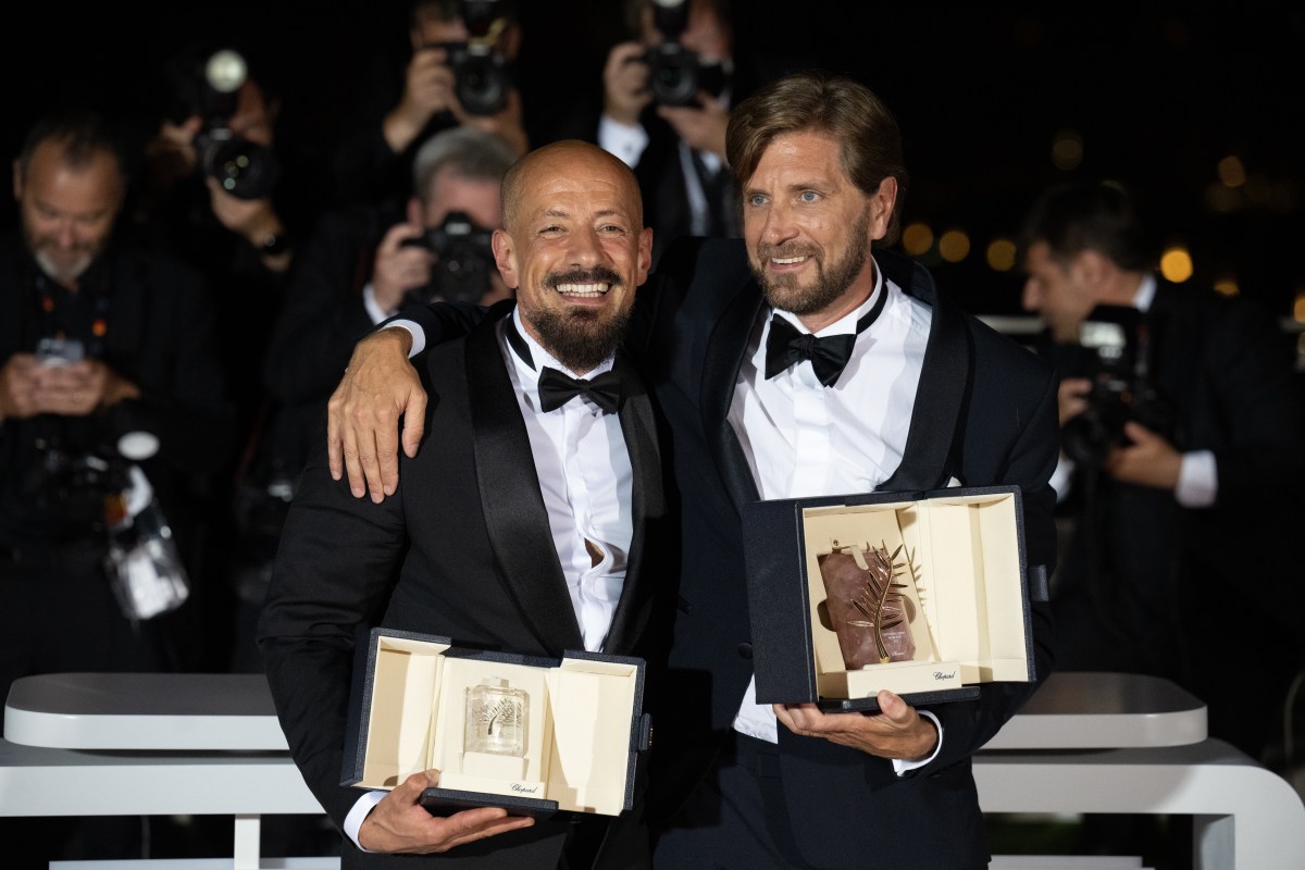 Ruben Ostlund (R) with the Palme D'or Award for "Triangle of Sadness" and Tarik Saleh (L) with the Best Screenplay Award for "Boy from Heaven" pose for a photo during the winner photocall during the 75th annual Cannes film festival.