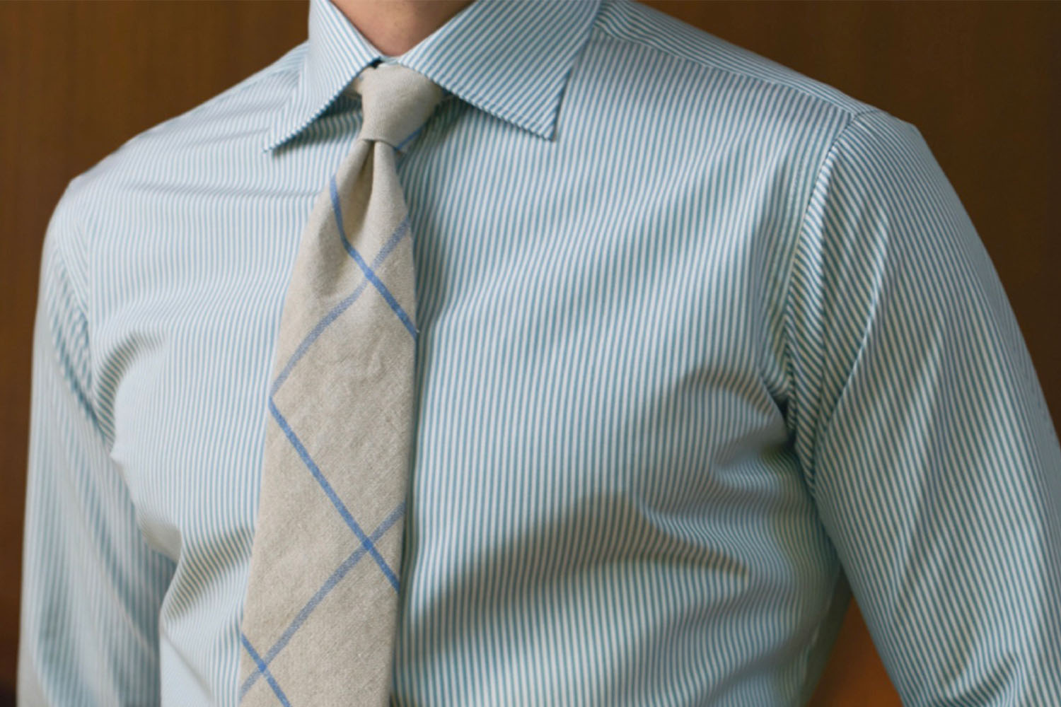 A close up shot of a model in a light blue Hamilton dress shirt