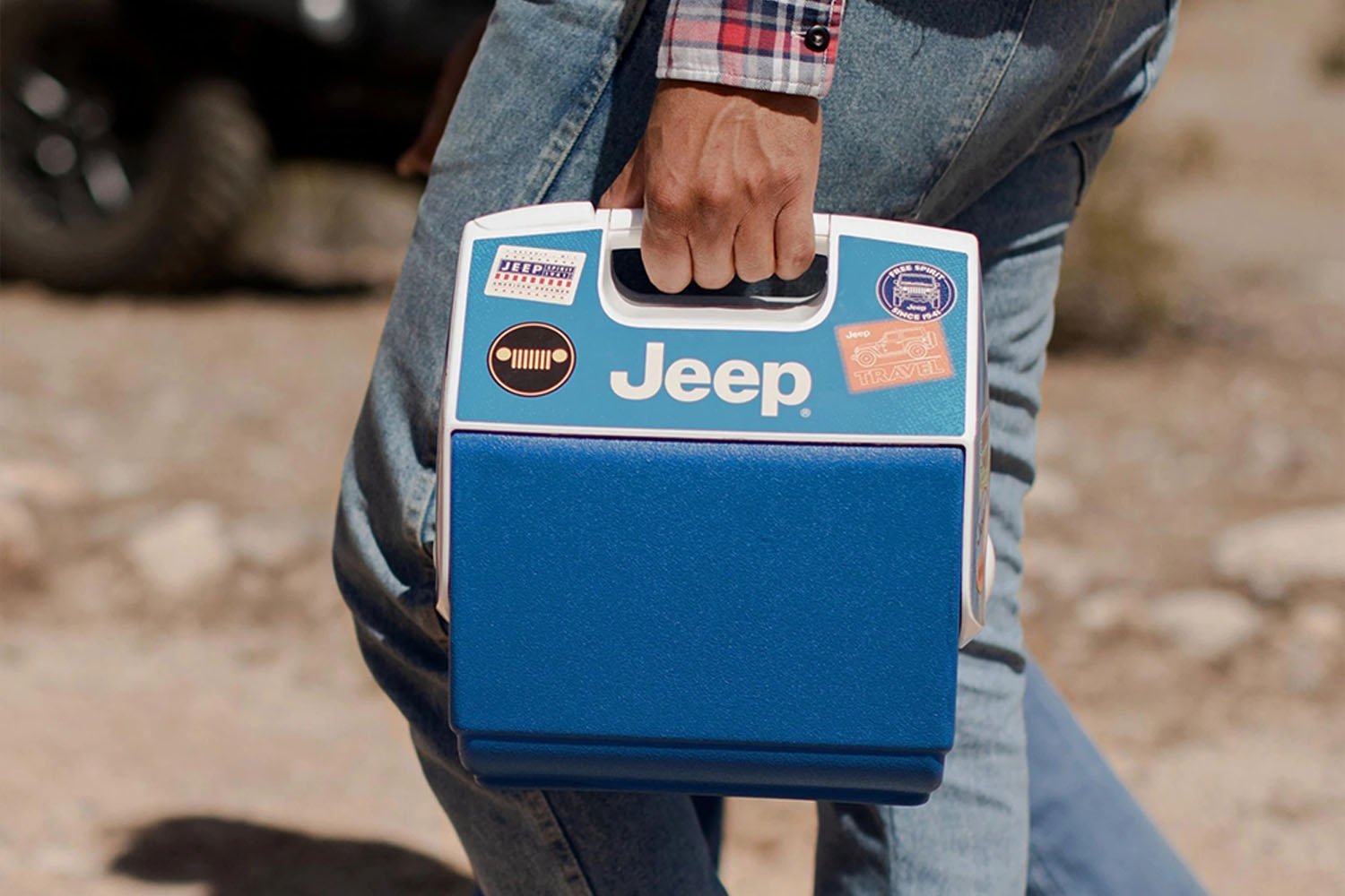 a Igloo cooler with Jeep branding being held by a model