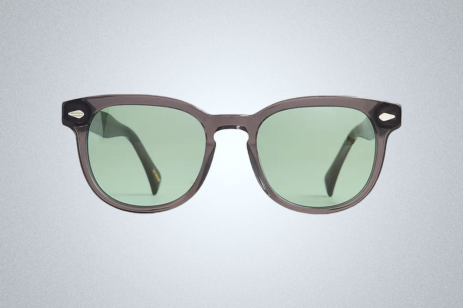 a pair of silver, blue lensed J.Crew sunglasses on a grey background