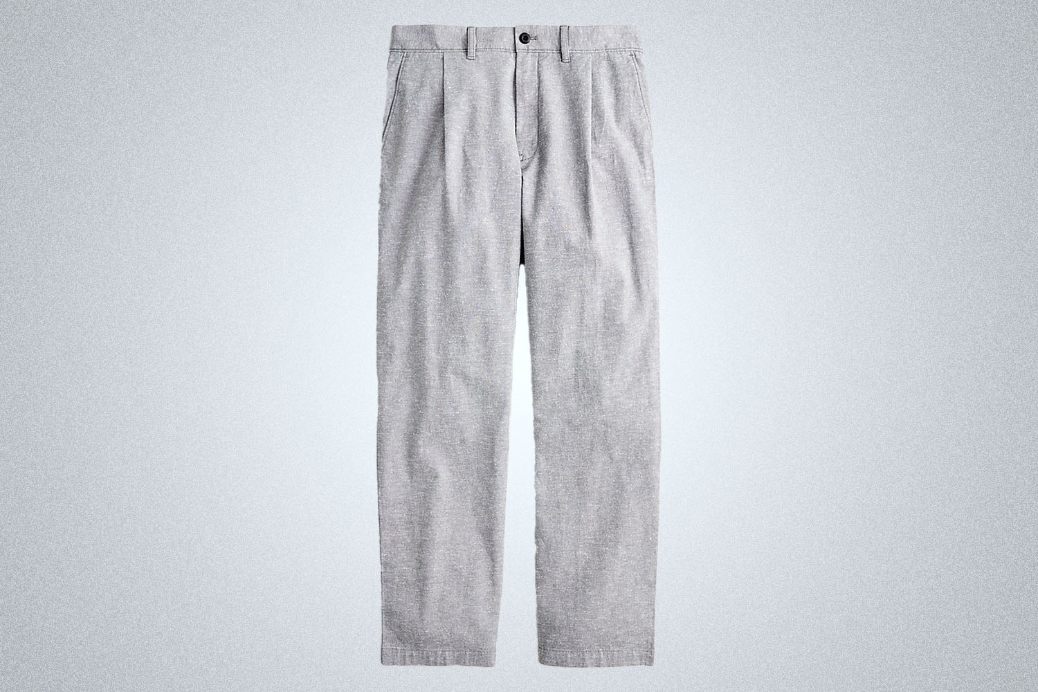 A pair of pleated grey linen pants from J.Crew on a grey background
