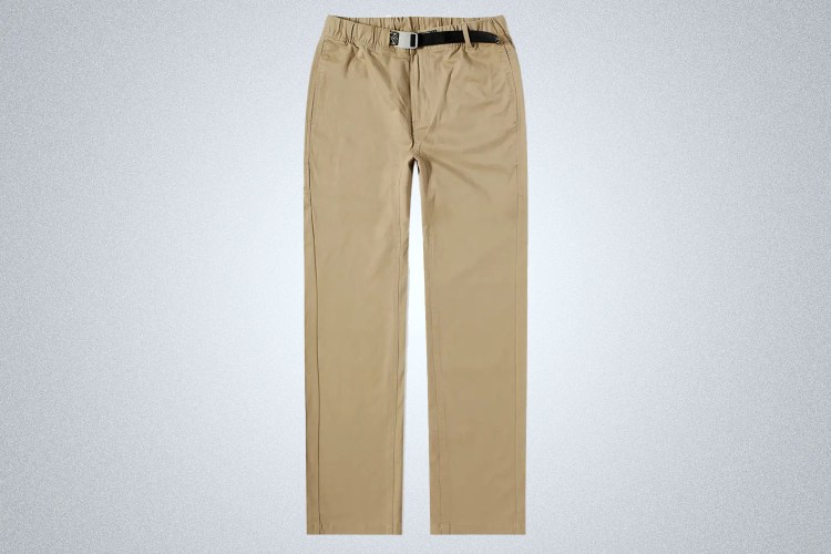 A pair of beige khaki outdoors pants from KAVU on a grey background