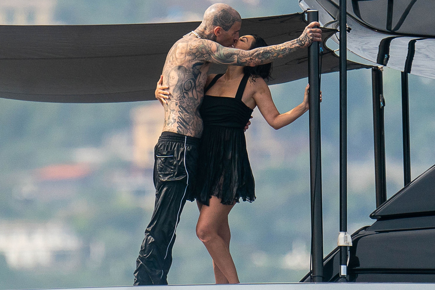 Kourtney Kardashian and Travis Barker make out on a boat in Italy