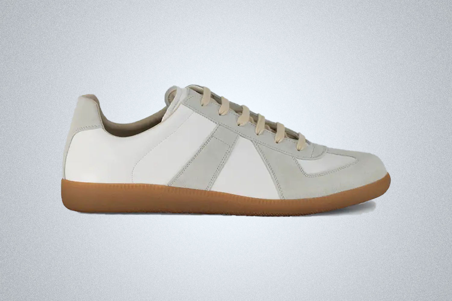 A pair of replica trainers from Maison Margiela on a grey background