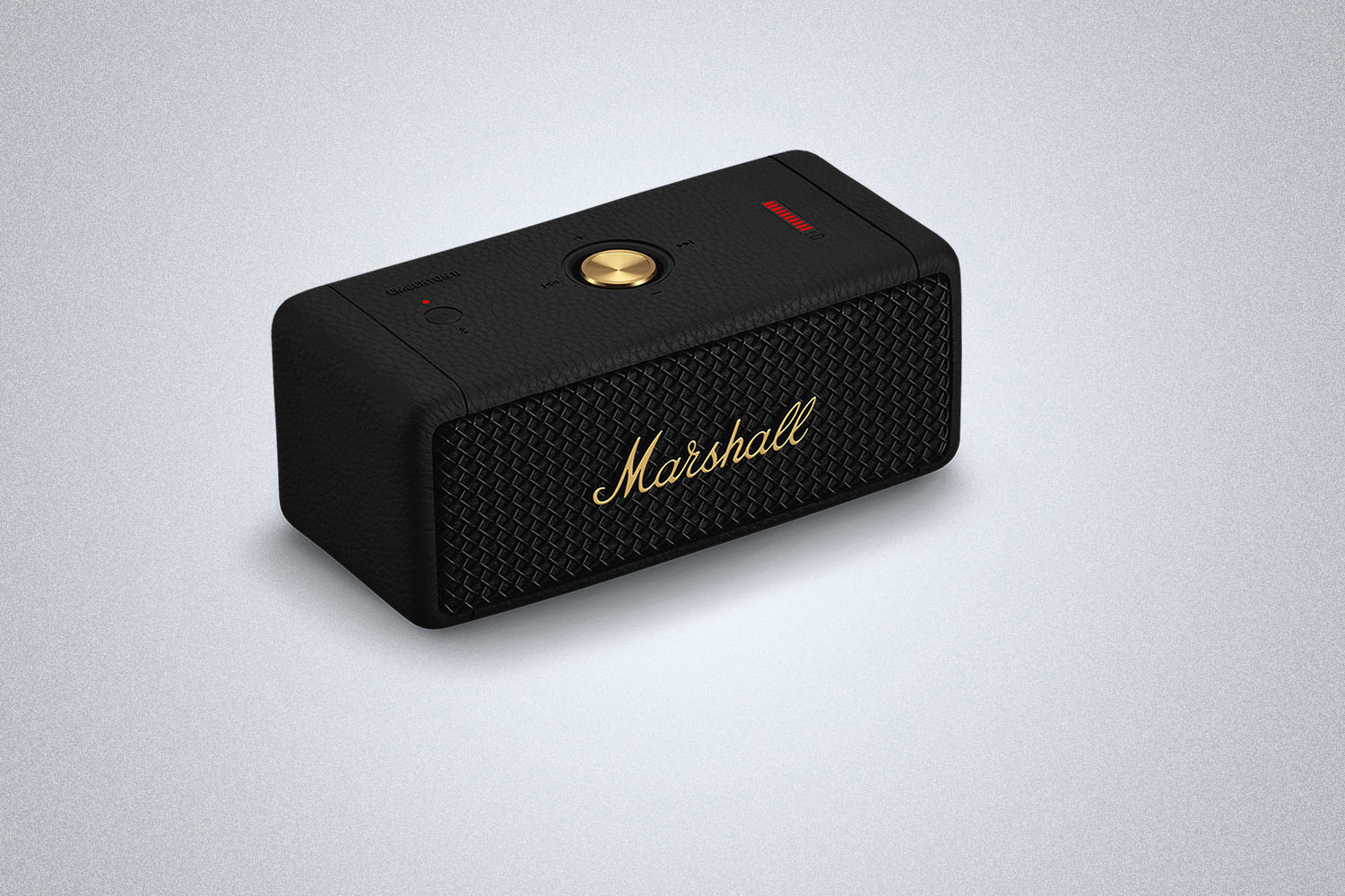 a black speaker with gold accents from Marshall on a gray background