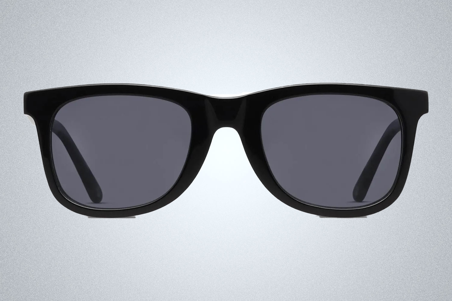 A pair of sunglasses from GlassesUSA on a grey background