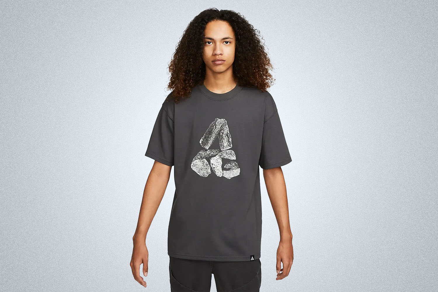 a black nike graphic tee on a grey background
