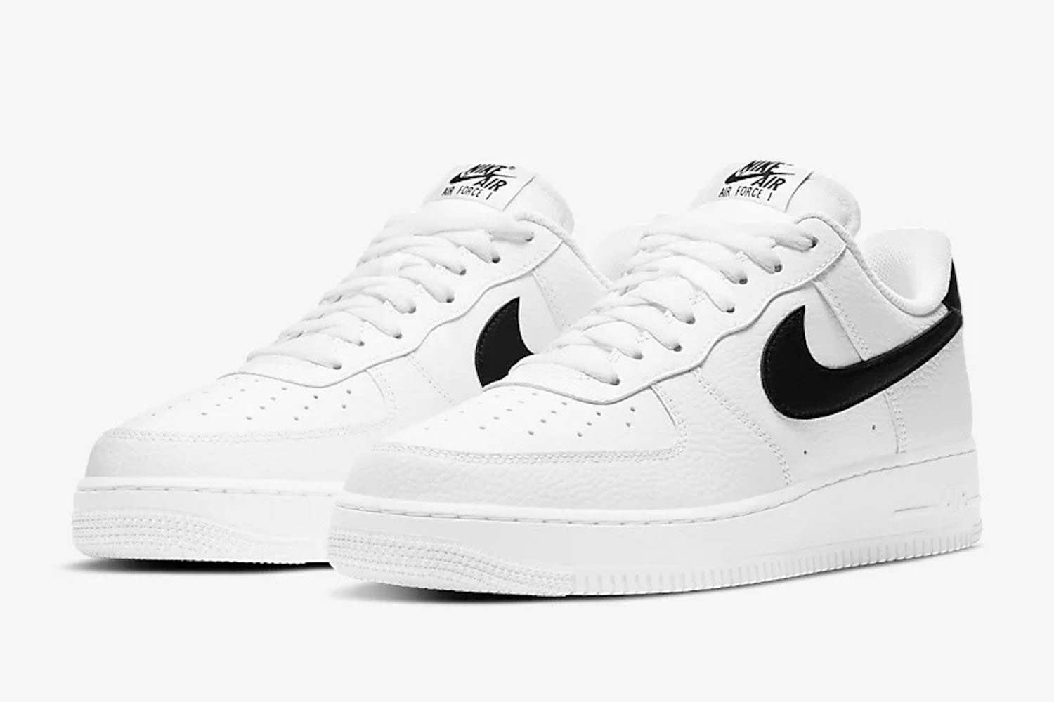 a pair of white and black accented Nike Air Force 1 '07's on a white background
