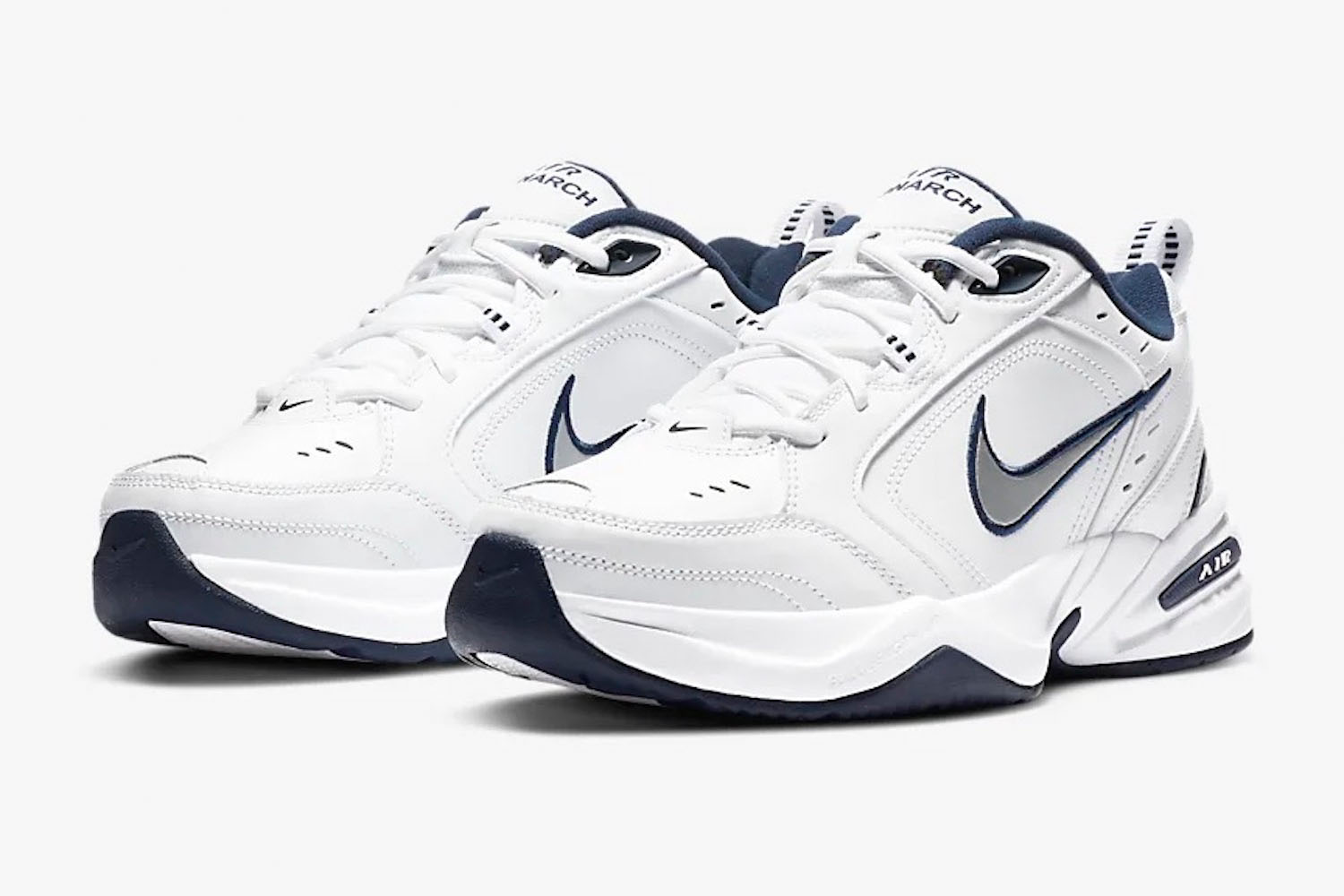 a pair of white and black accented Nike Air Monarch IV's on a white background