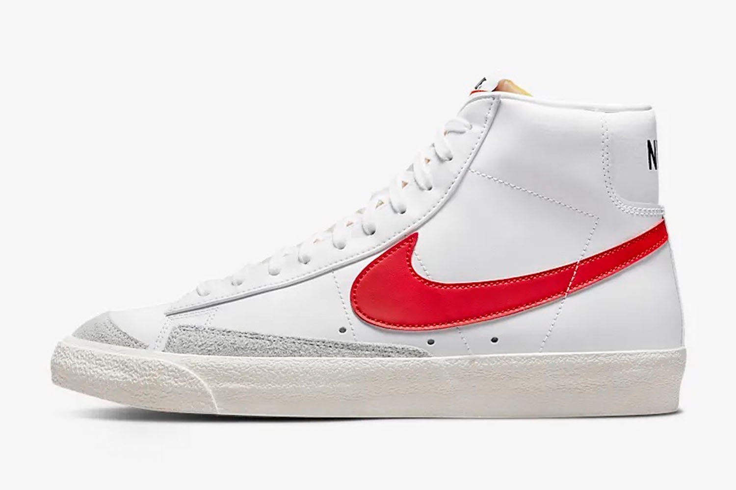 a pair of white and red accented Nike Blazer Mid '77 sneakers from Nike on a white background