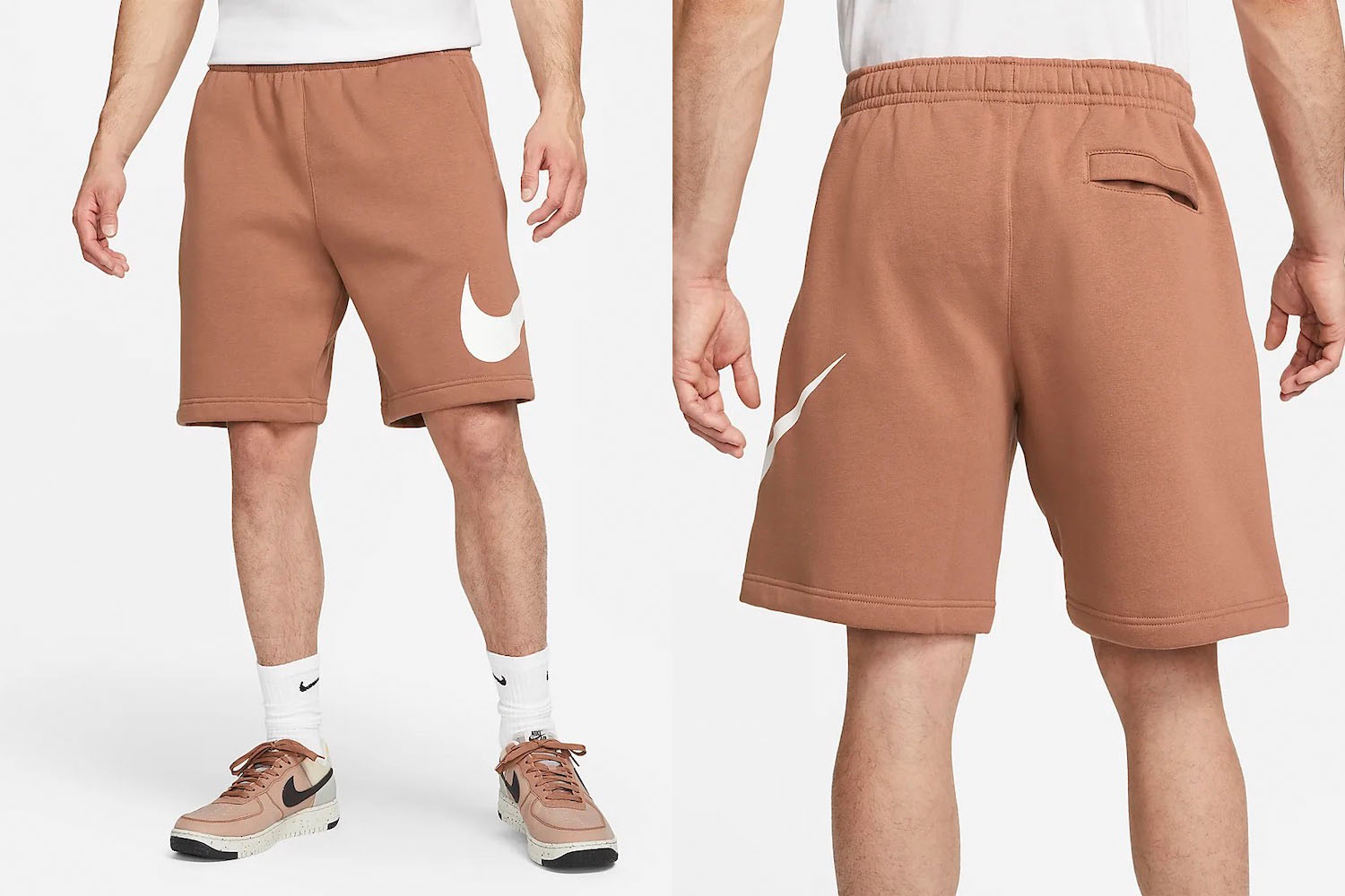 a pair of brown nike sweat shorts on a model on a white background 