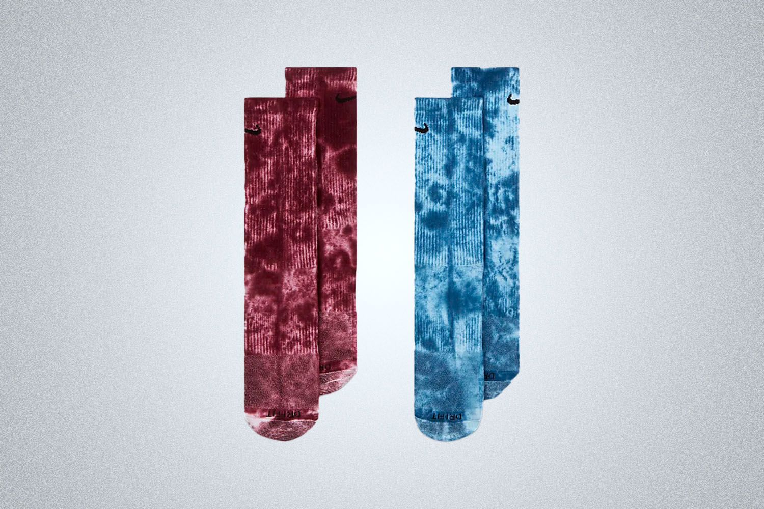 two pairs of nike tie dye socks on a grey background