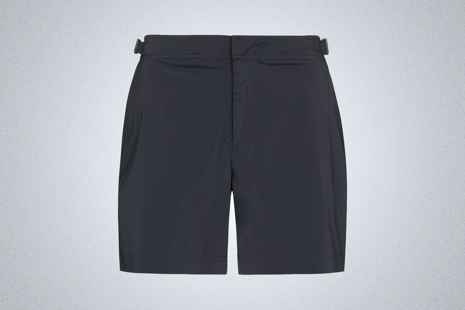 a pair of navy swim trunks from Orlebar Brown on a grey backgroud
