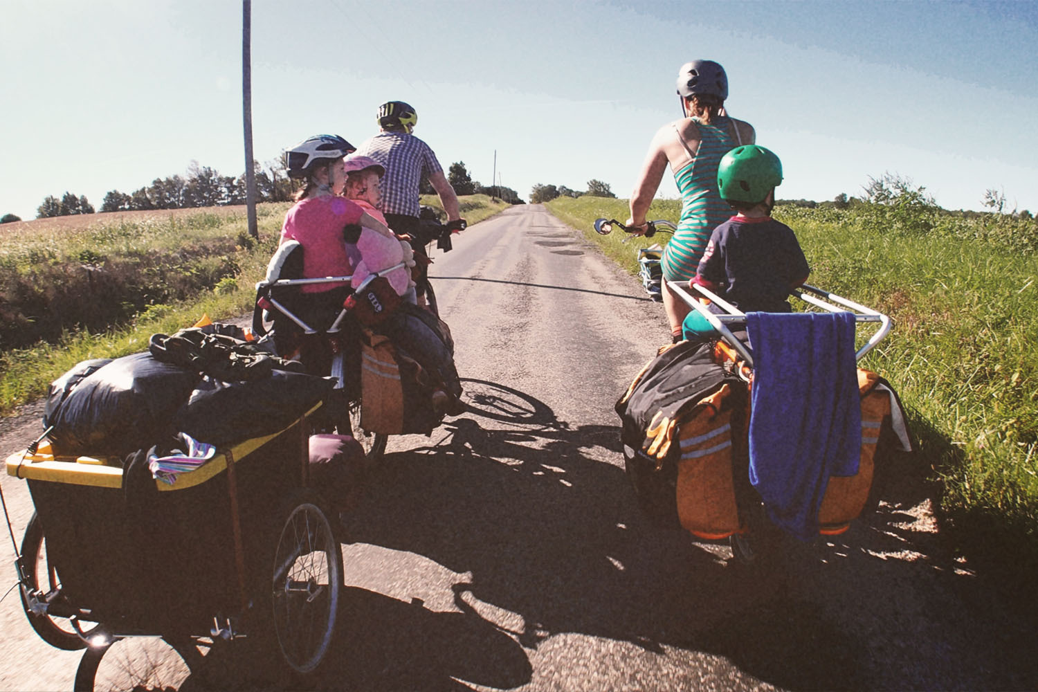 Parents hauling their kids on cargo bikes